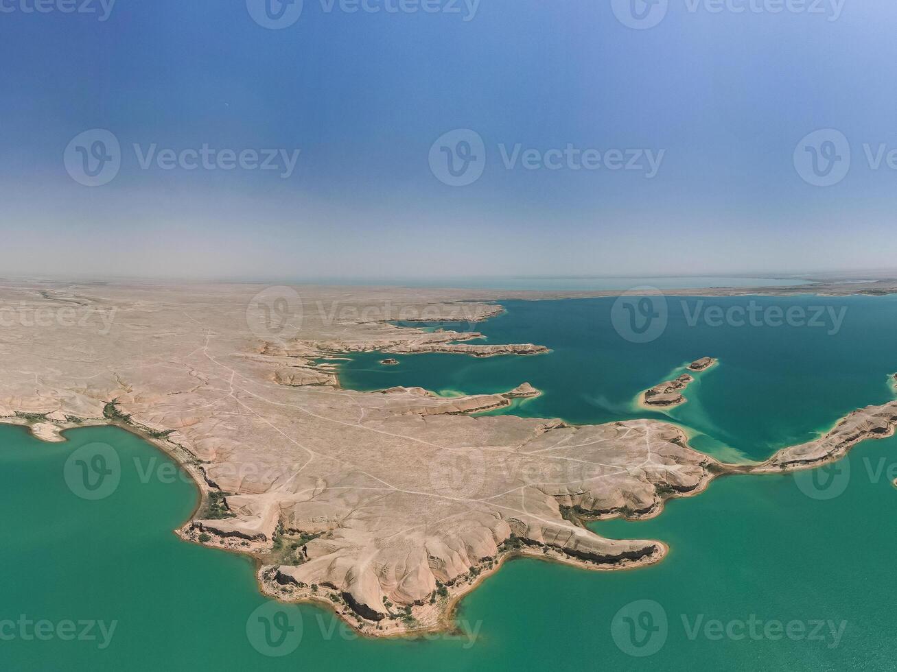 Expansive Kuimazar Reservoir meeting desert landscape under blue Uzbekistan sky photo