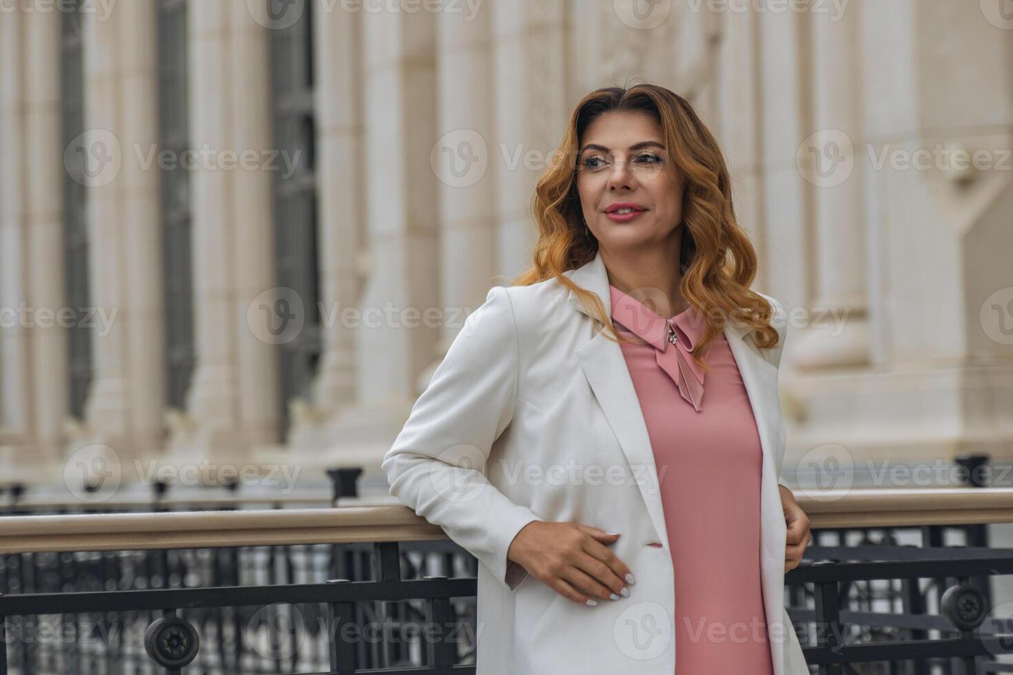 Woman White Blazer Pink Dress Smiling Posing Outdoor Architecture Background photo