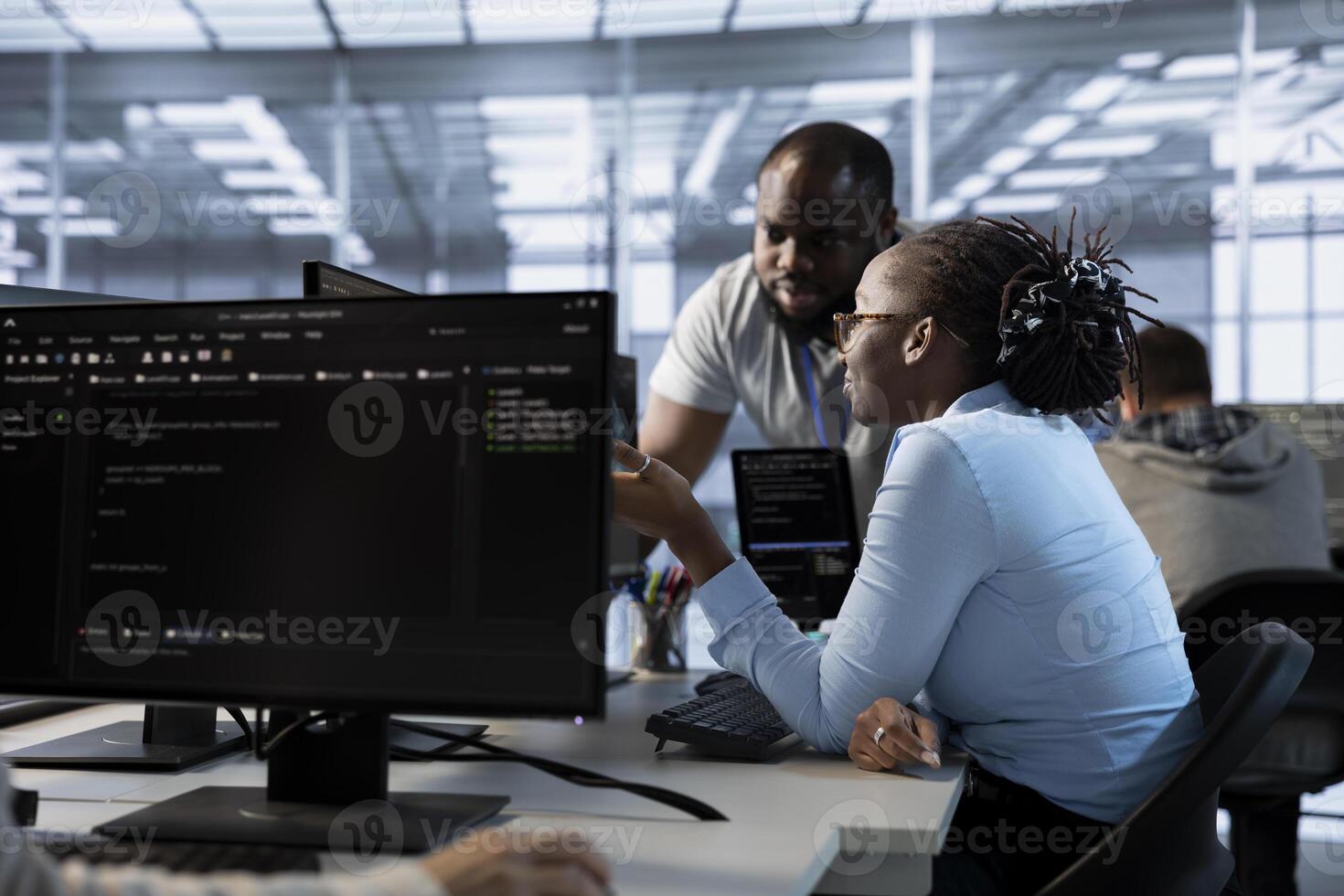 Team of engineers talking in server hub, ensuring compliance with industry standards and regulatory requirements. Data center teamworking colleagues conducting security audits photo