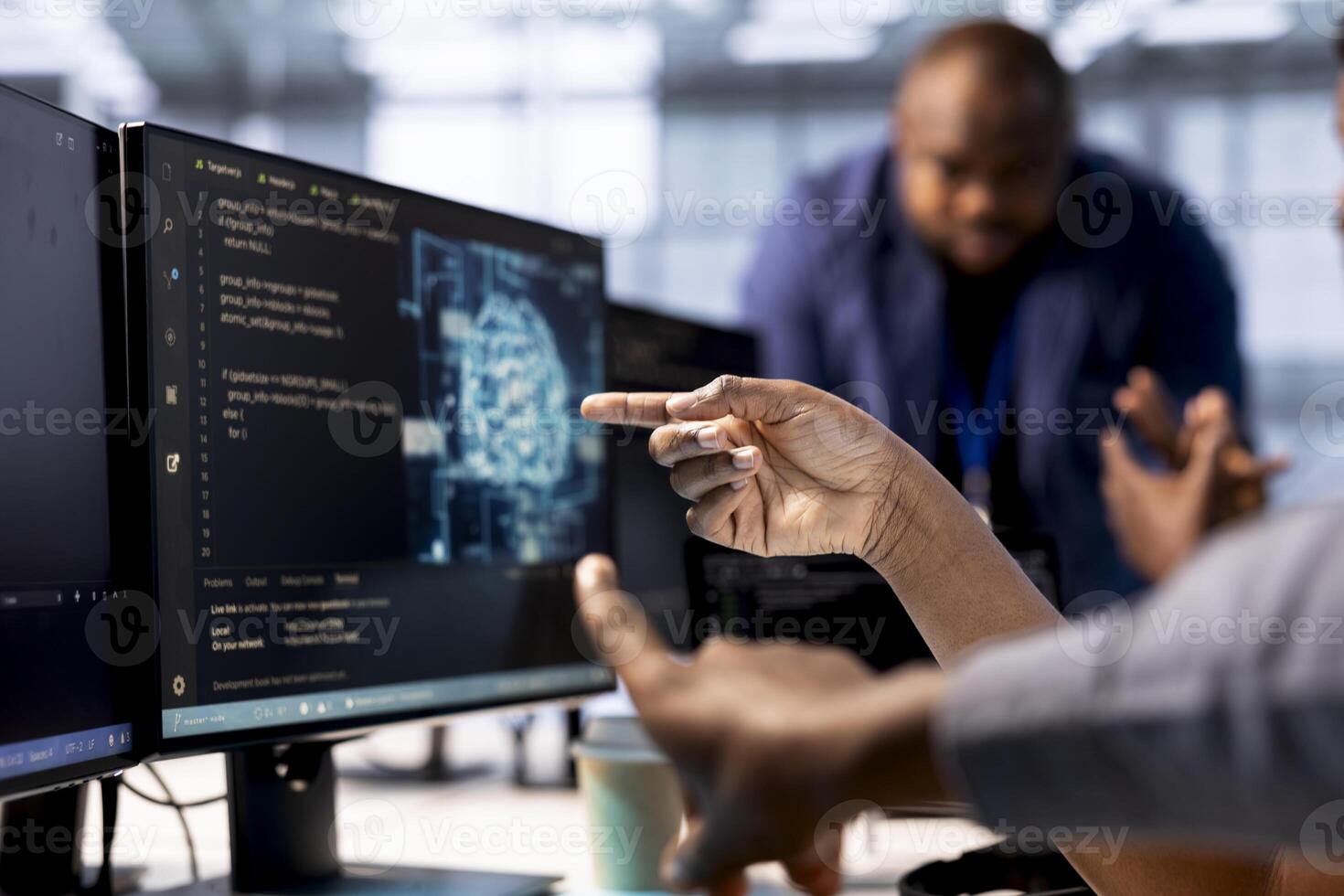 Server farm admin showing colleague AI technology on computer, creating and implementing algorithms. Close up of data center worker pointing finger to artificial intelligence tech on PC photo