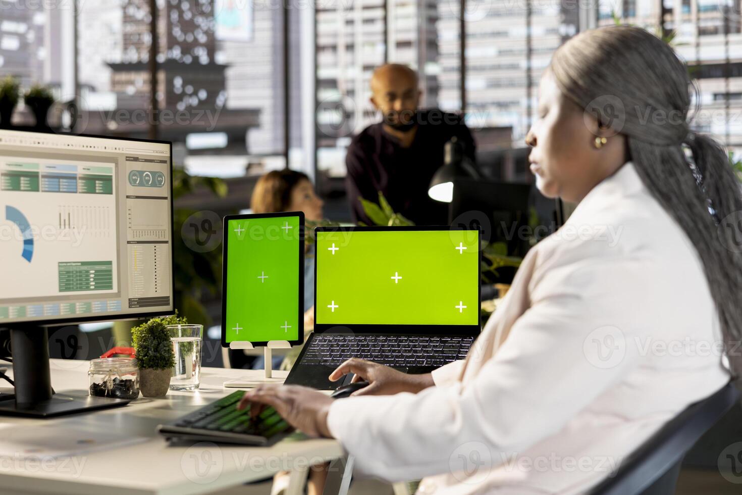 Business professional working on financial report next to chroma key screen at desk, planning a new development and expansion strategy. Worker focuses on effective resource allocation. photo