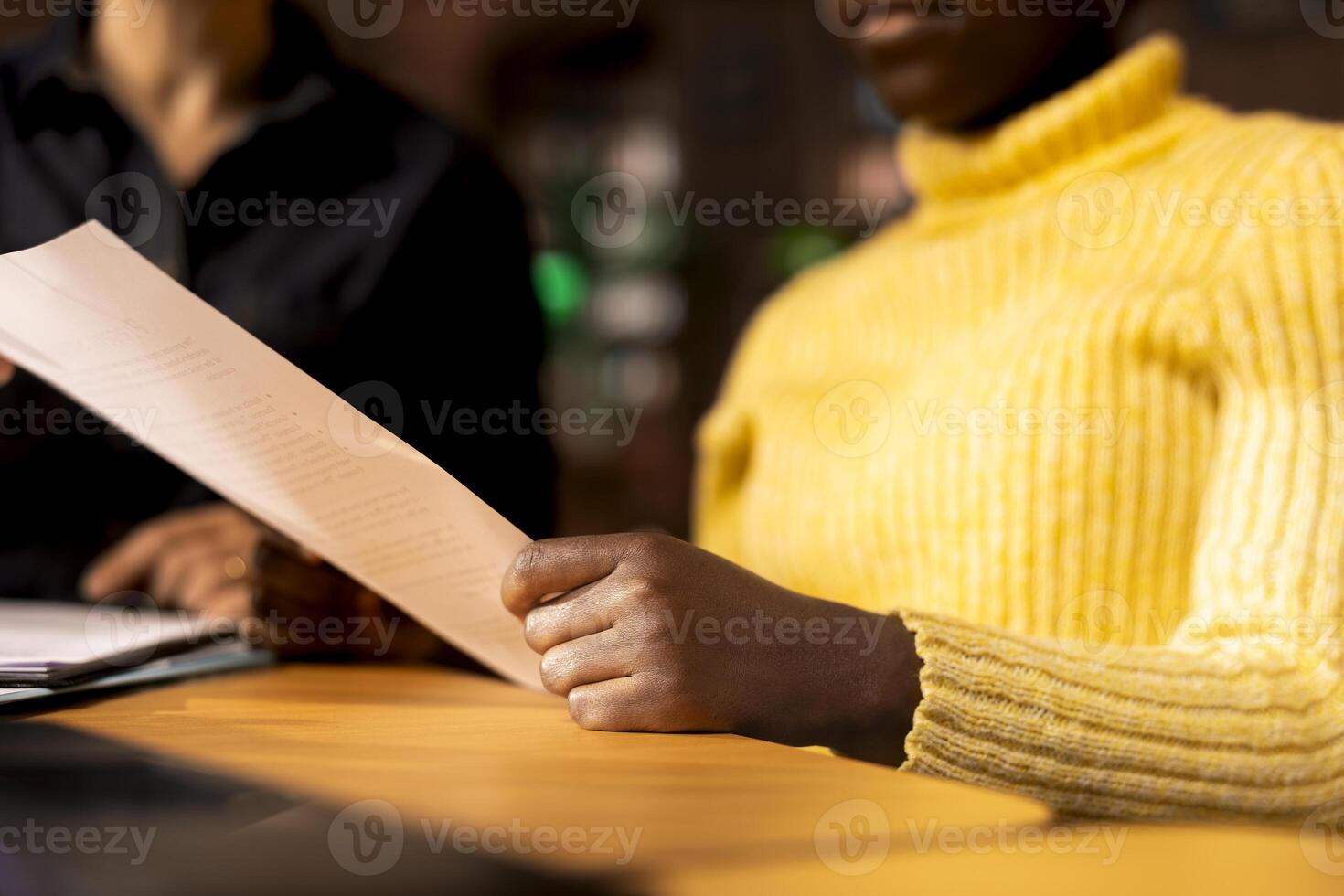 African american schoolgirl receiving personalized learning materials based on school curriculum, ensuring academic success through knowledge and research. Tutoring in a library. Close up. photo