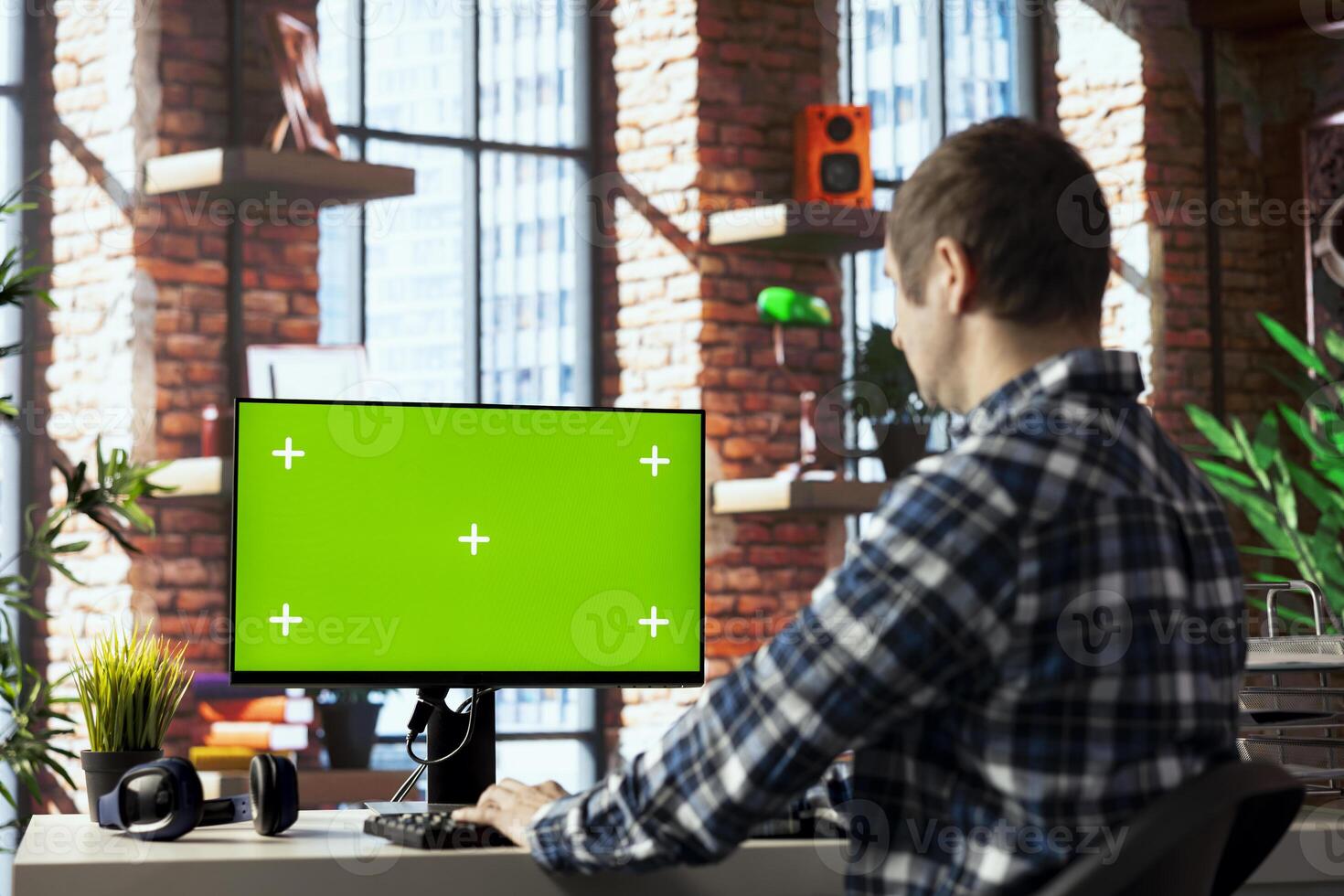 Man in home office using mockup computer, preparing presentation slides, adjusting layouts. Employee finishing company project, writing summaries, saving files on green screen PC, uploading materials photo