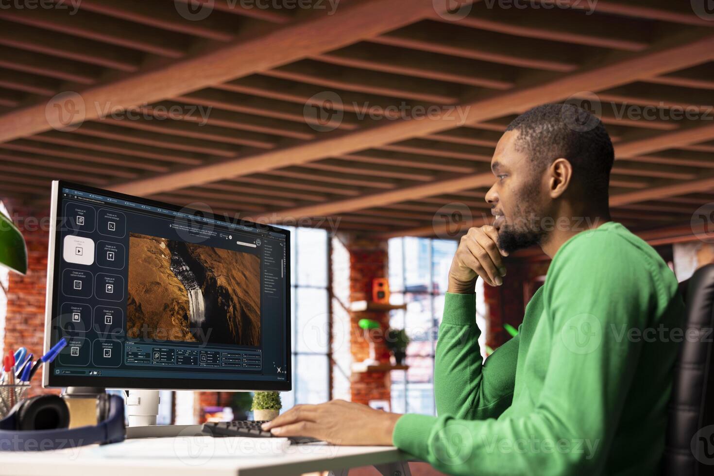 Smiling man at home getting tasks done with AI program turning text prompt into videos. Happy person using computer to make use of text to artificial intelligence generative models photo