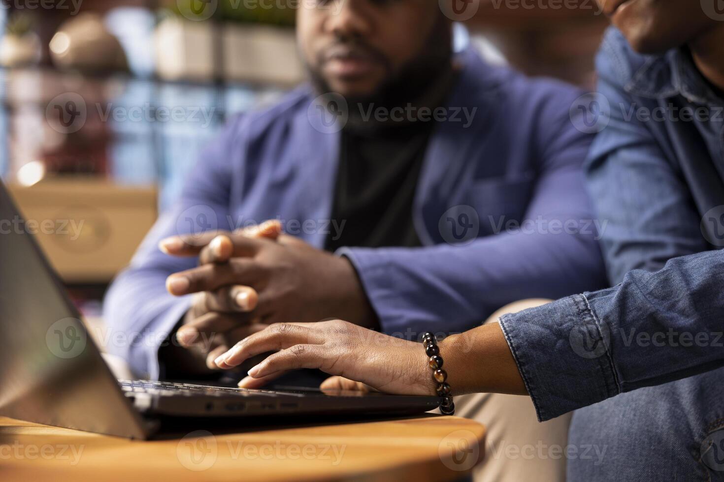 Ambitious people learning a new language sitting in the living room, browsing the internet for study platforms. Couple using a language learning software online on laptop. Close up. photo