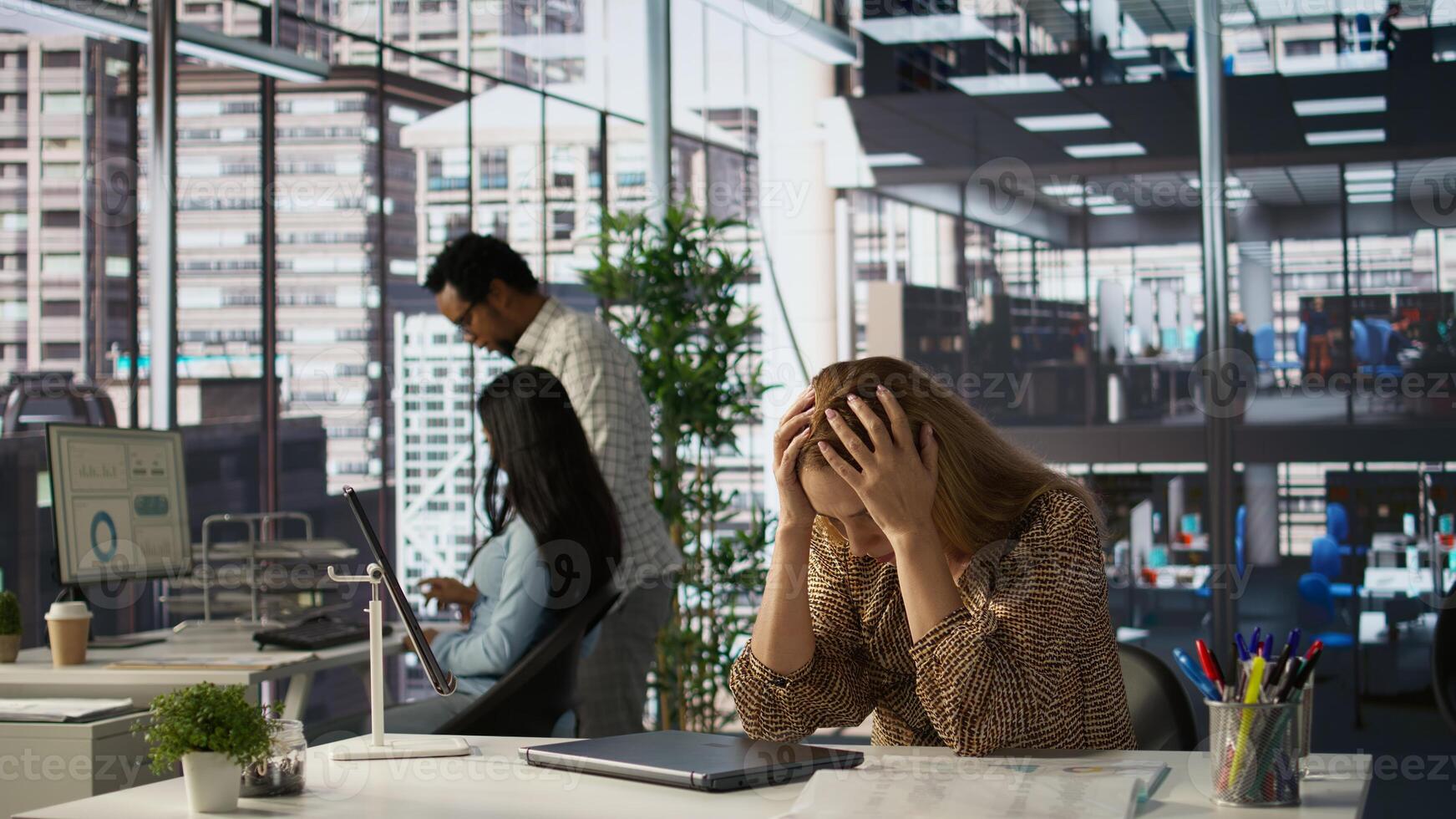 Entrepreneur feels emotional strain and frustration of business failure, disappointment and challenges. Mental exhaustion as she struggles to find solutions for professional struggle. Camera B. photo