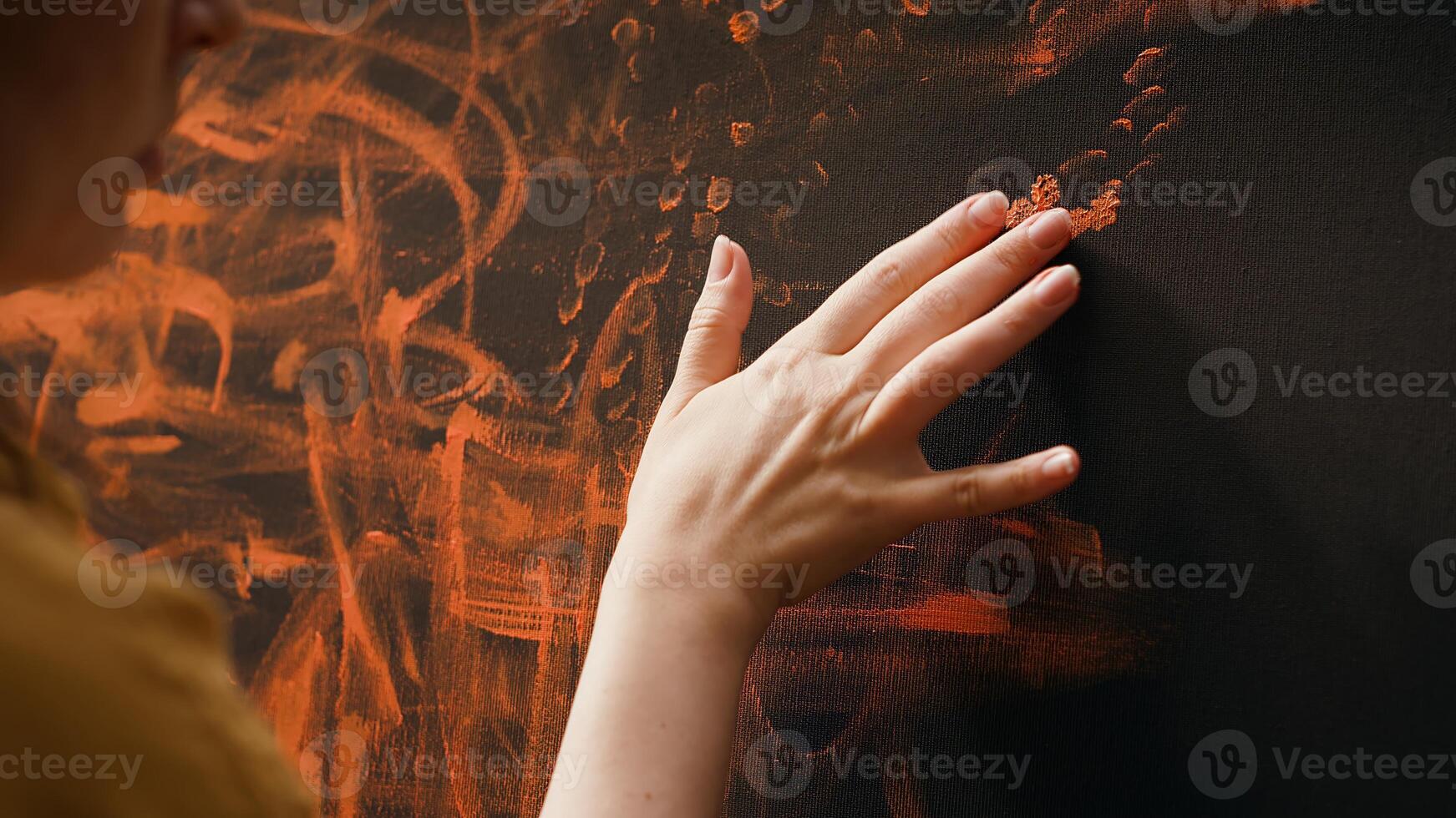In an art studio, artist uses watercolor paint to create a finger painted masterpiece. Talented painter showing her inspiration to create a rustic colorful artwork with handprints. Camera A. photo
