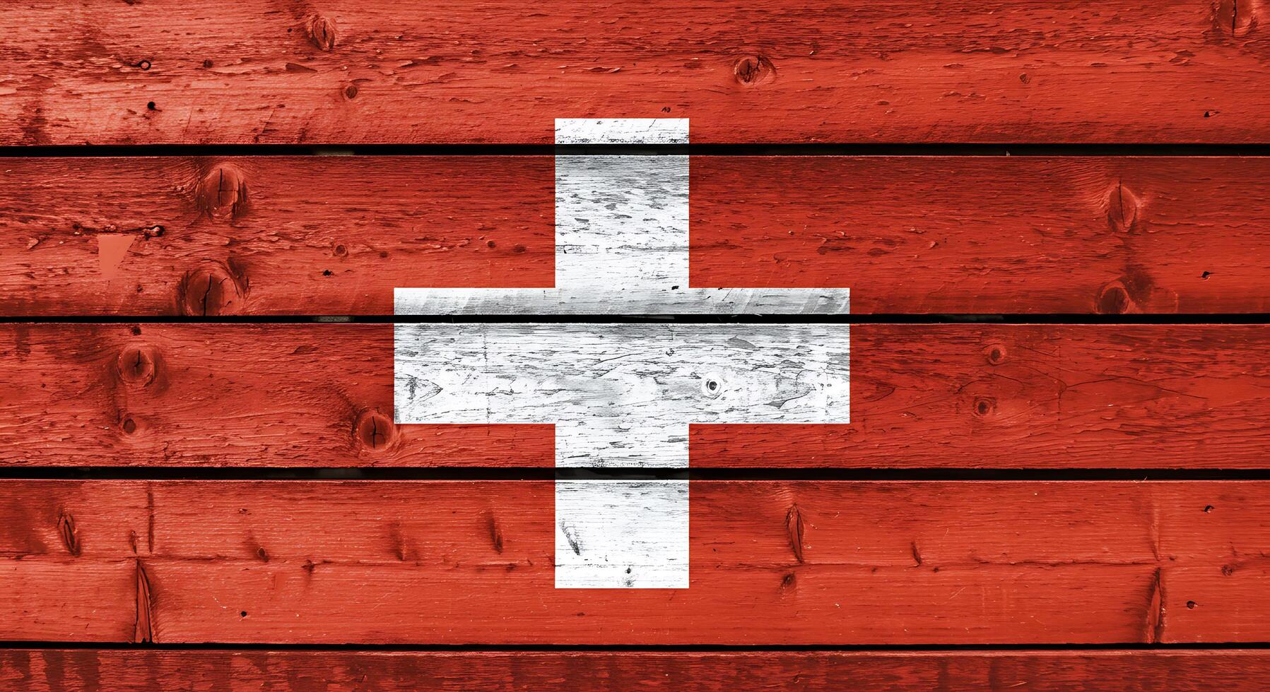 A close up of the swiss flag painted on a wooden wall photo
