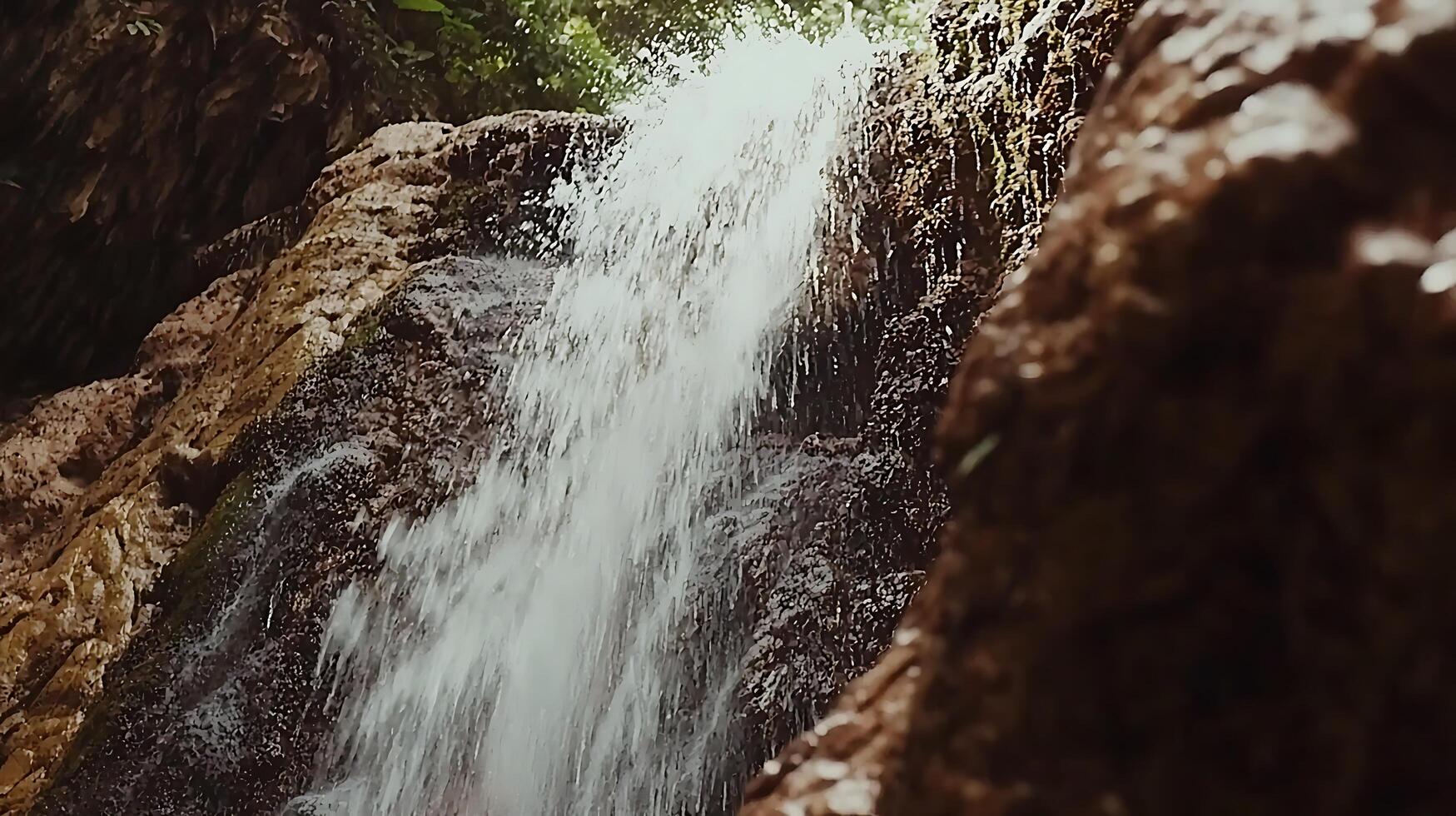 Refreshing Waterfall Cascading Down Mossy Rocks in Lush Forest. photo