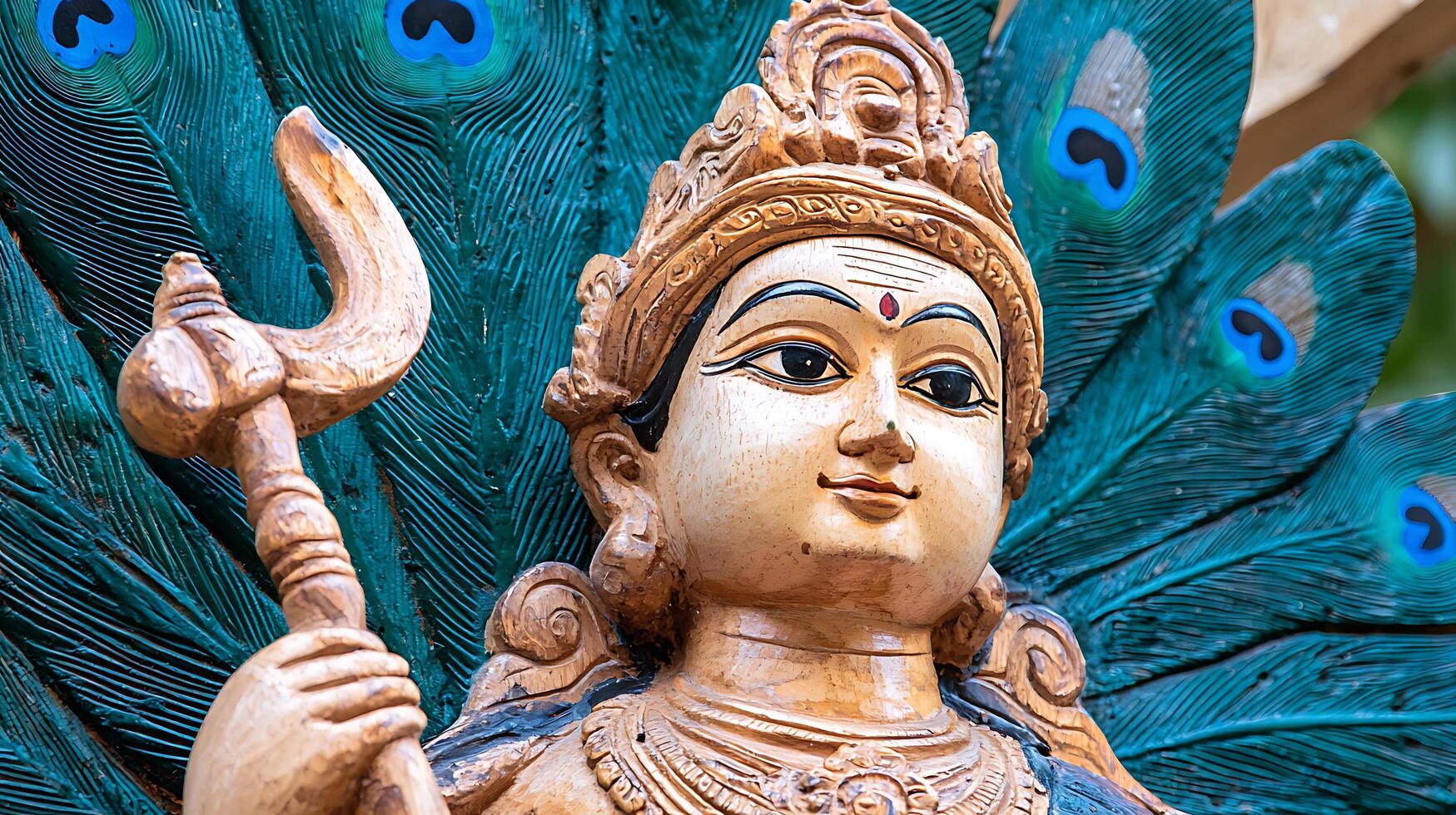 Ancient Statue with Vibrant Peacock Feathers Showcases Cultural Heritage. photo