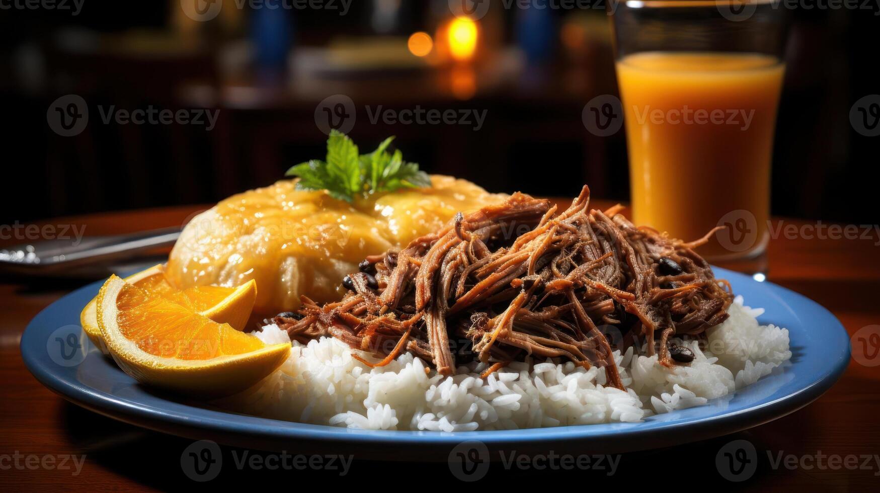 Pulled pork with rice, orange slices, and a refreshing drink. photo