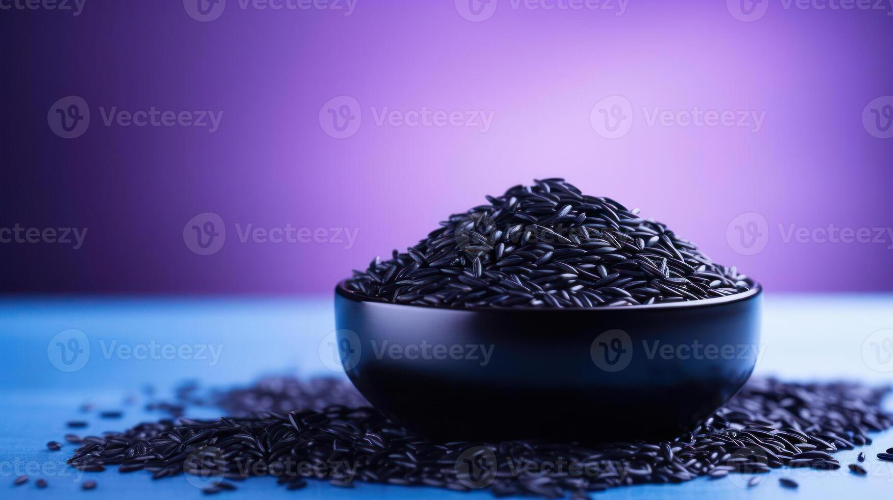 Black rice in a bowl, scattered grains, vibrant background. photo