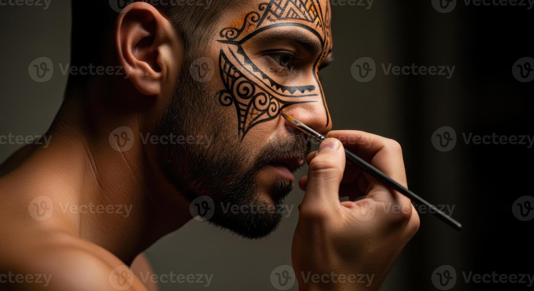 Man applying intricate tribal face paint design with a brush, close up profile view photo