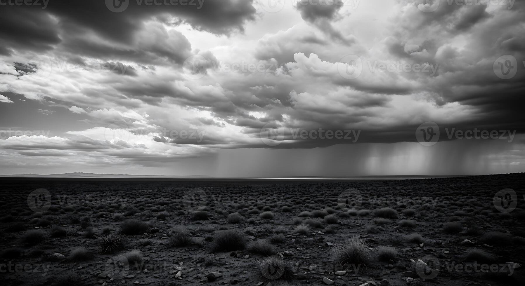 Black and white photo of storm clouds over a desert