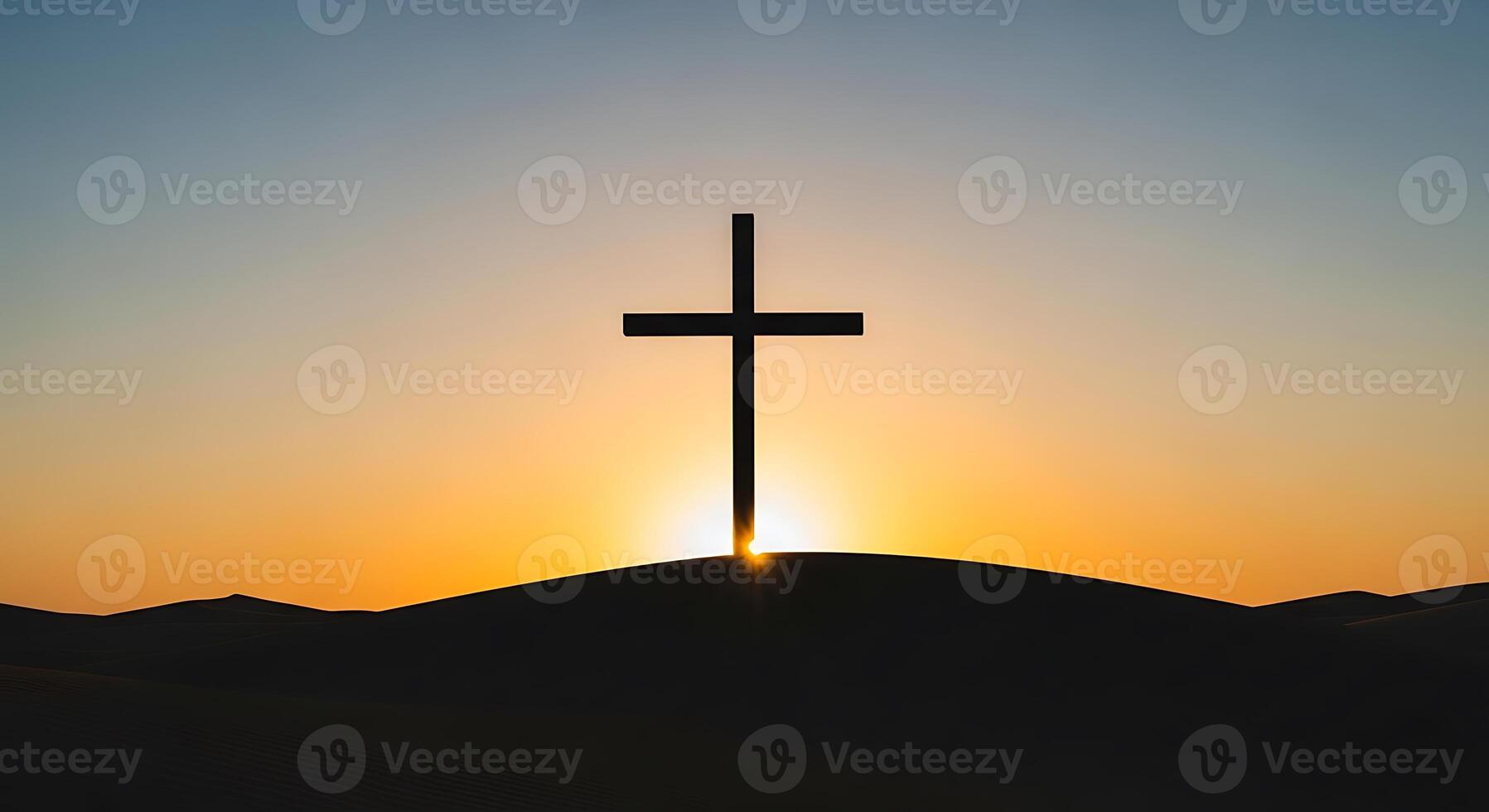 A cross is silhouetted against the sunset photo