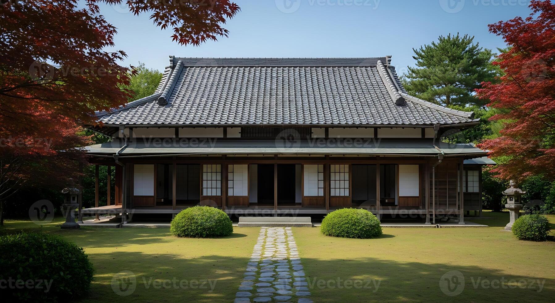 A japanese style house with a large roof and a path photo