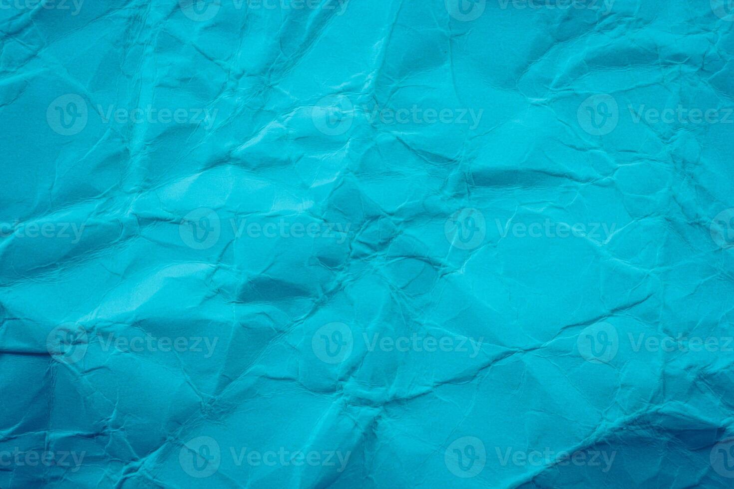 Crumpled paper background with blue color photo