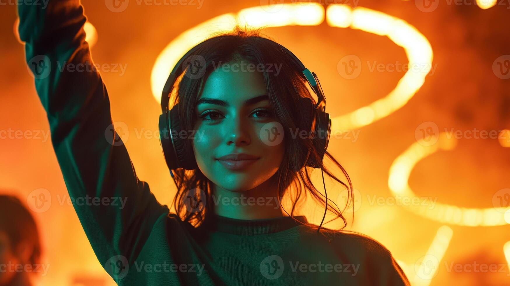 A young woman wearing headphones at a nightclub photo