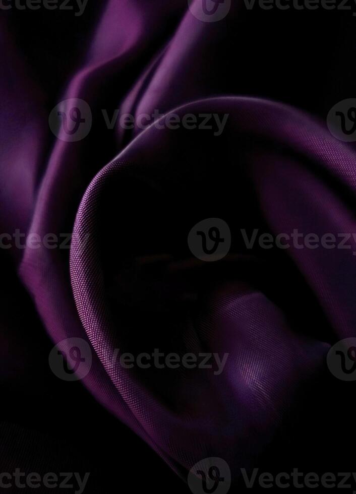 Close-up of crumpled vibrant purple textured fabric. Can be used as background for advertising jewelry, jewelry, luxury, graphic design. photo