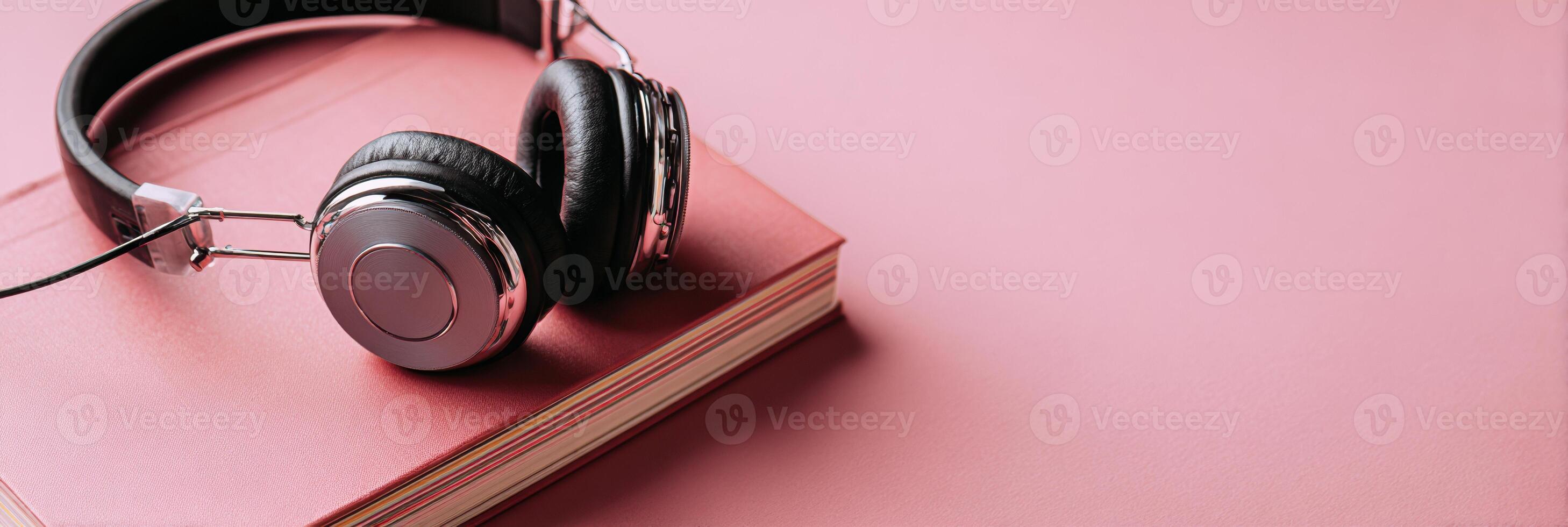 Headphones Resting on a Notebook Symbolize the Essence of Listening and Creativity in a Calm, Minimalistic Setting photo