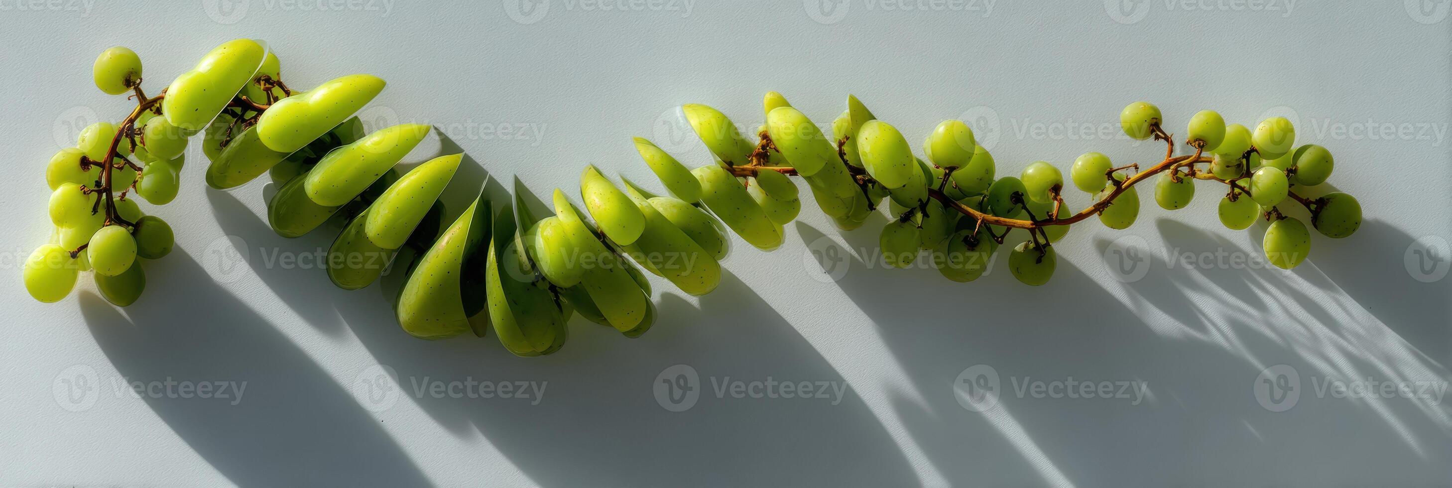 Grapes Arranged in an Abstract Spiral With Dynamic Shadow Play Against a Smooth Surface photo