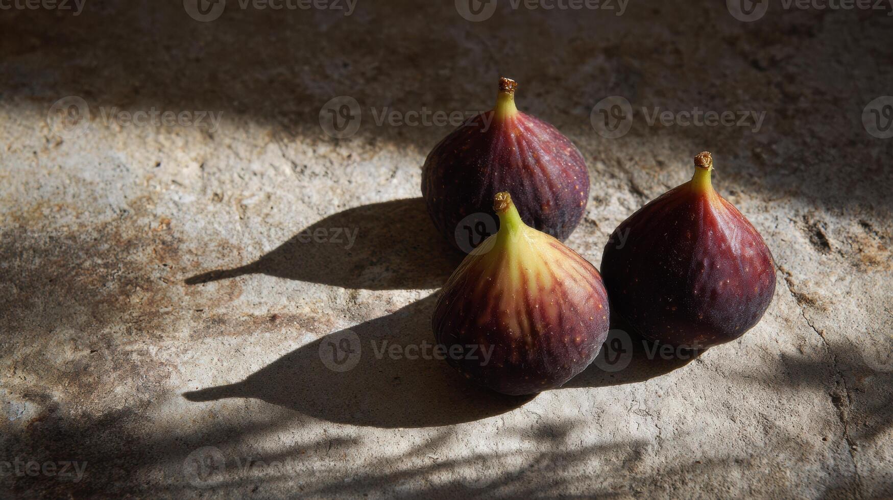 Fresh Figs Arranged on a Stone Slab Create Shadows on a Sunlit Surface With One Area Left Untouched photo