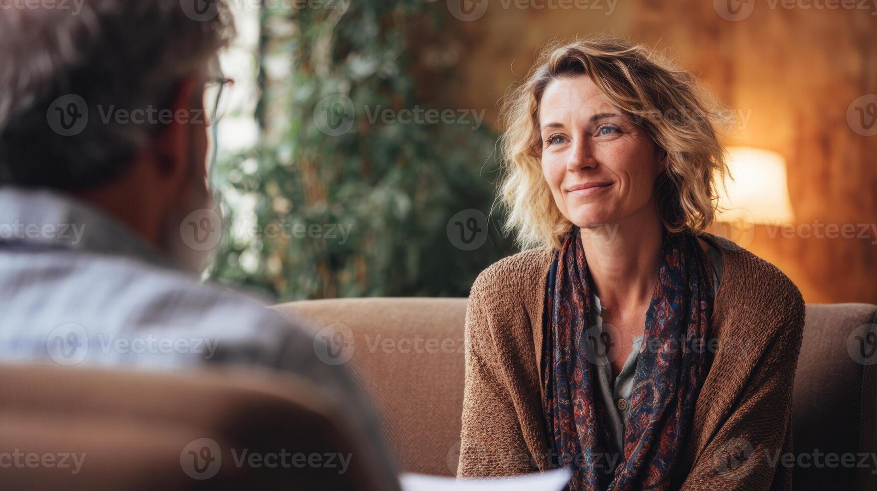 Therapist Engaging in Supportive Conversation With a Client in a Warm, Inviting Setting During a Counseling Session photo
