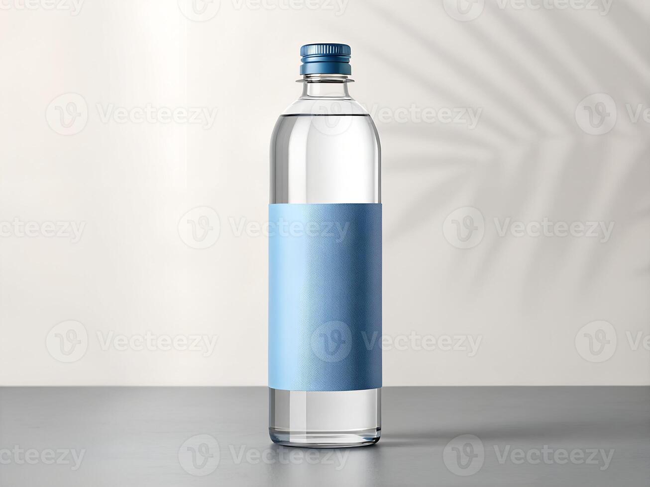 Clear Glass Water Bottle with Light Blue Label on Grey Surface photo