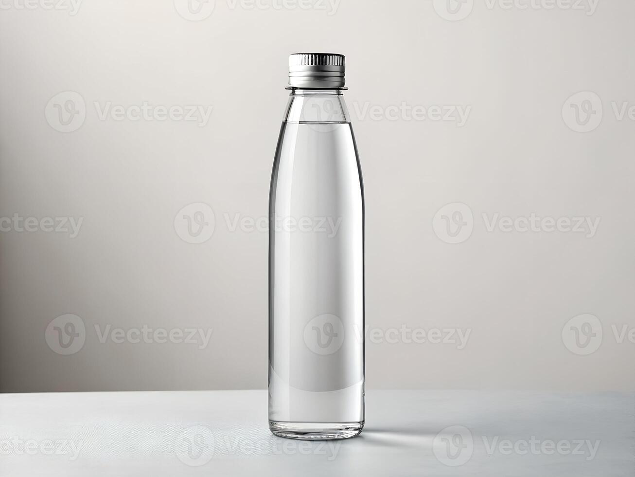 Clear Glass Water Bottle with Silver Cap on White Background photo