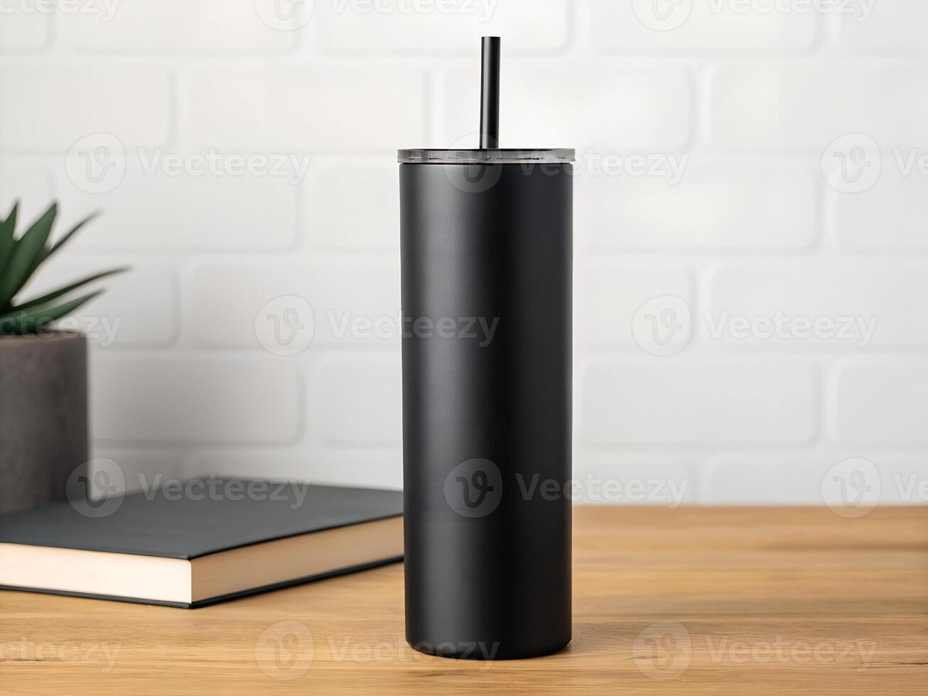 Black Matte Stainless Steel Tumbler with Straw on Wooden Table photo
