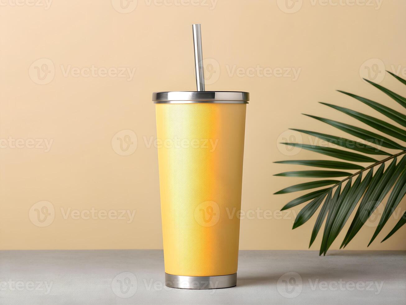 Yellow Textured Stainless Steel Tumbler with Palm Leaf on Neutral Background photo
