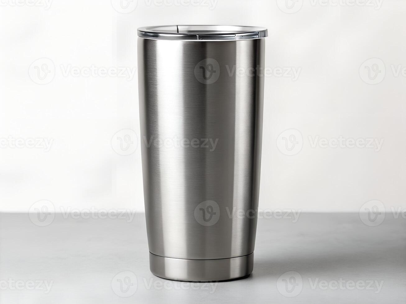 Brushed Stainless Steel Tumbler on Grey Surface photo