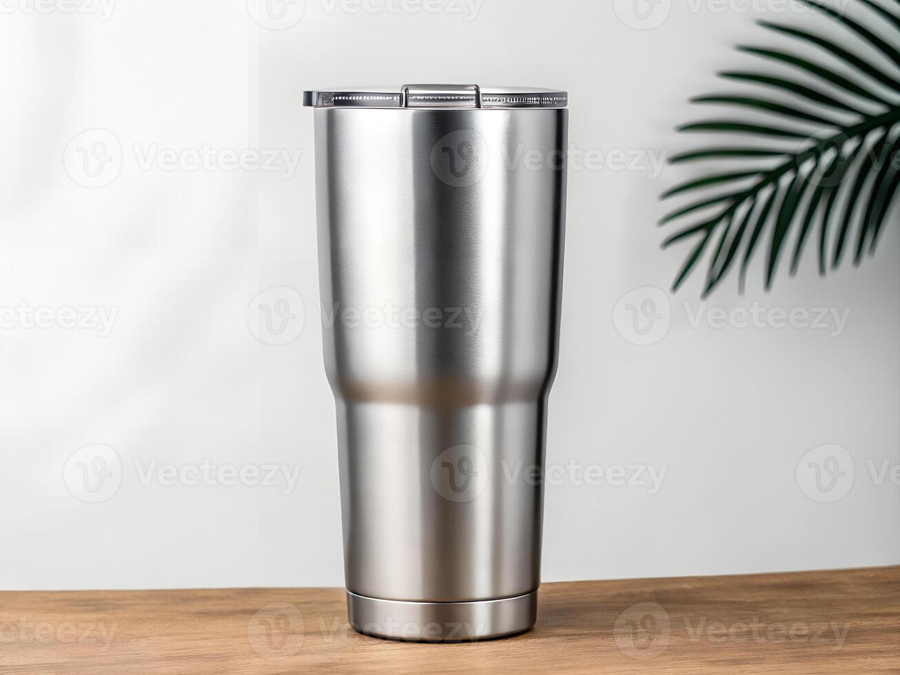 a stainless steel tumbler on a table photo