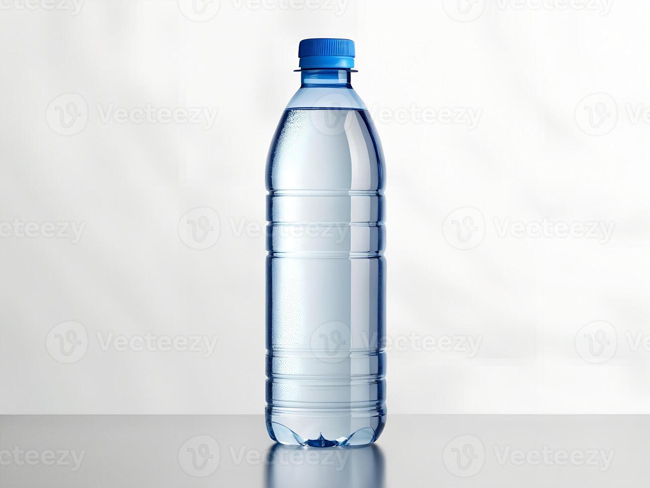 Clear Plastic Water Bottle with Blue Cap on White Background photo