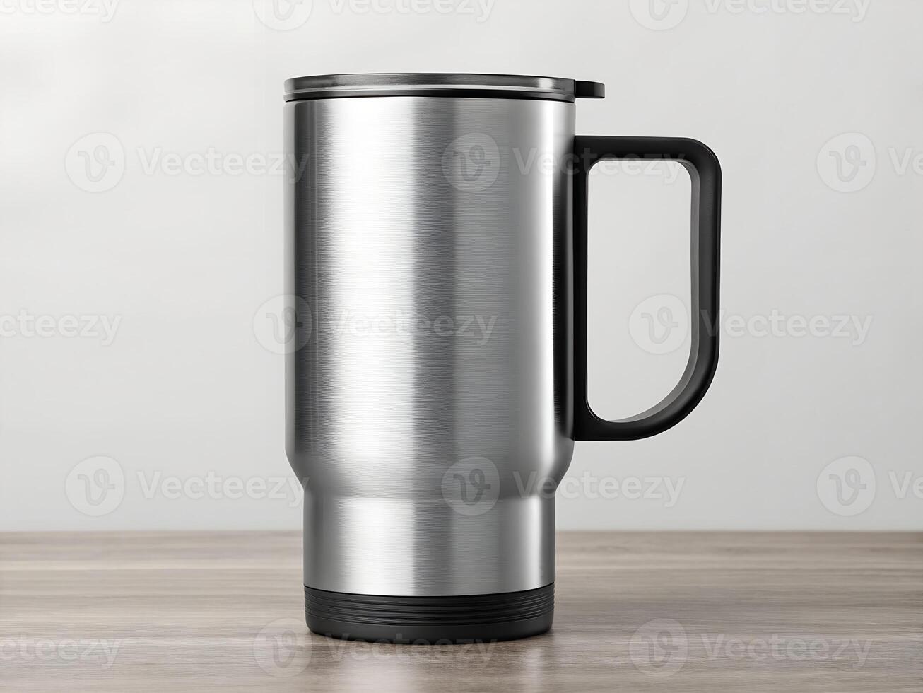 Silver Brushed Stainless Steel Travel Mug with Black Handle on Wooden Table photo
