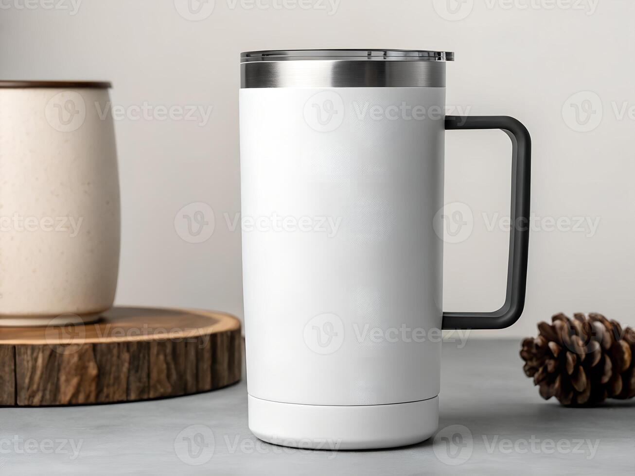 White Stainless Steel Travel Mug with Black Handle on Grey Surface photo