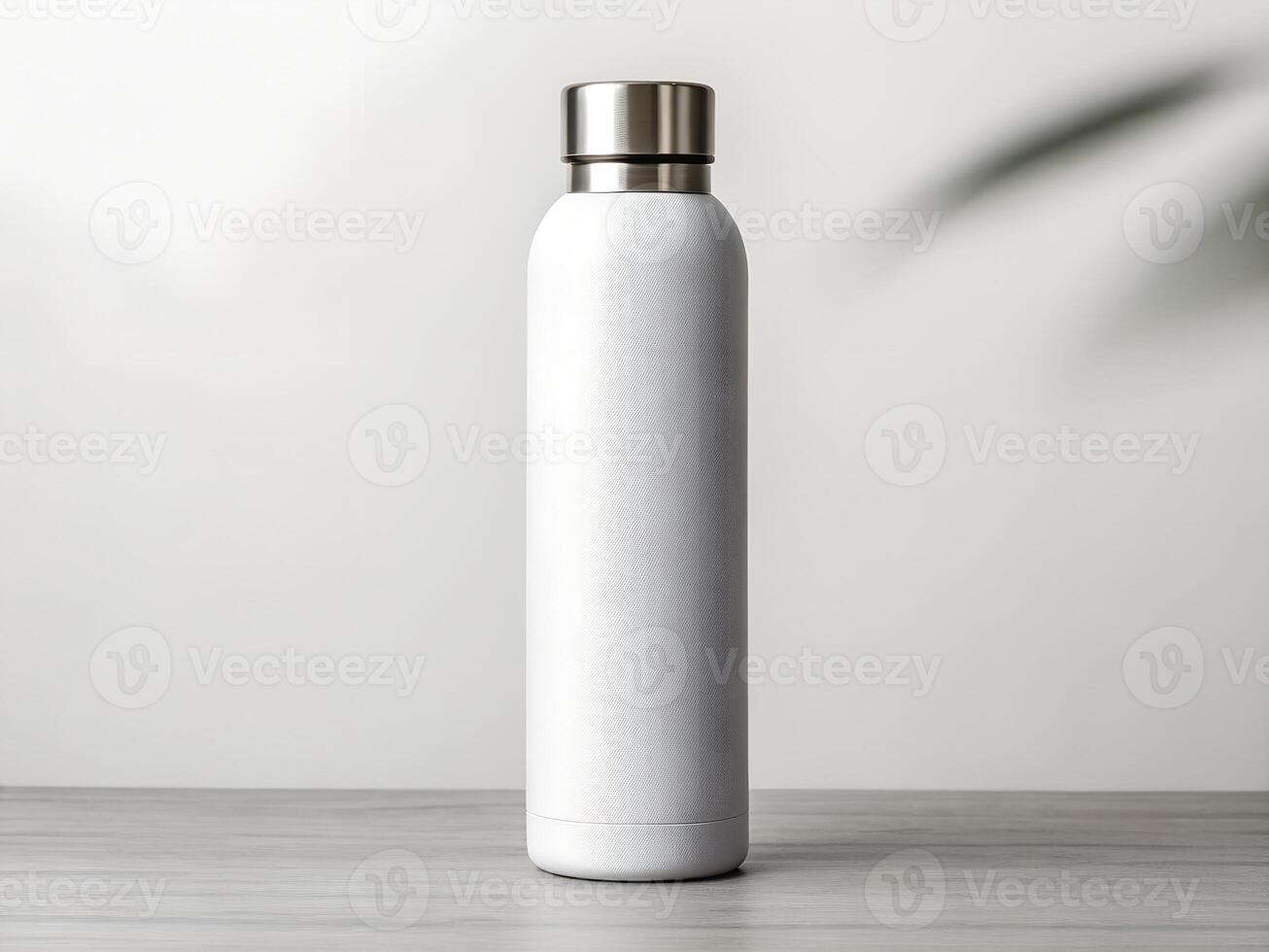 White Speckled Stainless Steel Water Bottle on Wooden Table photo