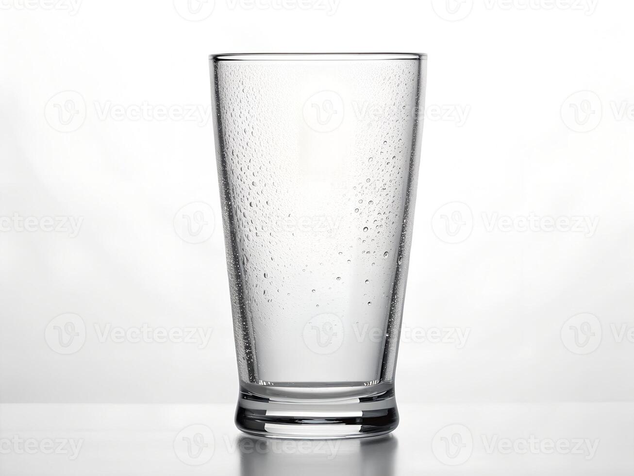 Clear Glass with Water Droplets on White Background photo