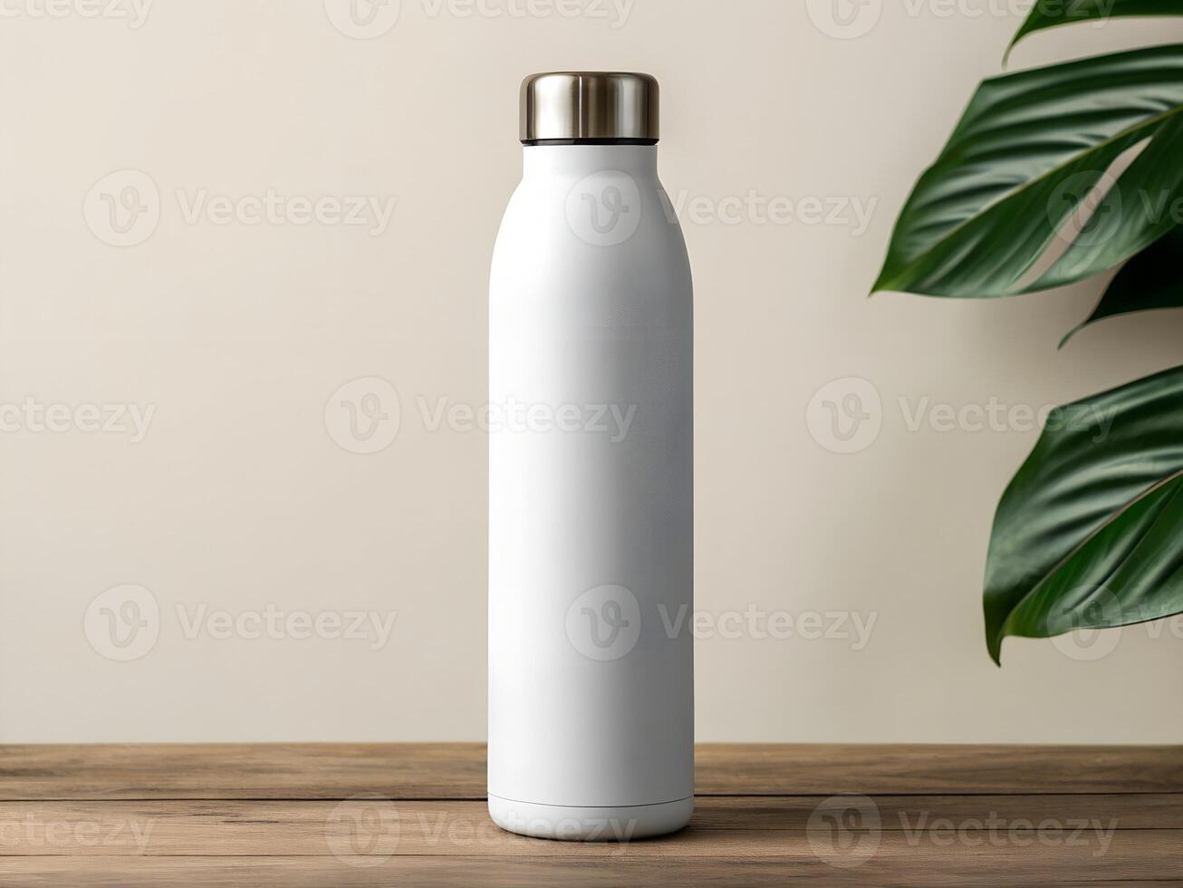 White Stainless Steel Water Bottle on Wooden Table with Tropical Leaves photo