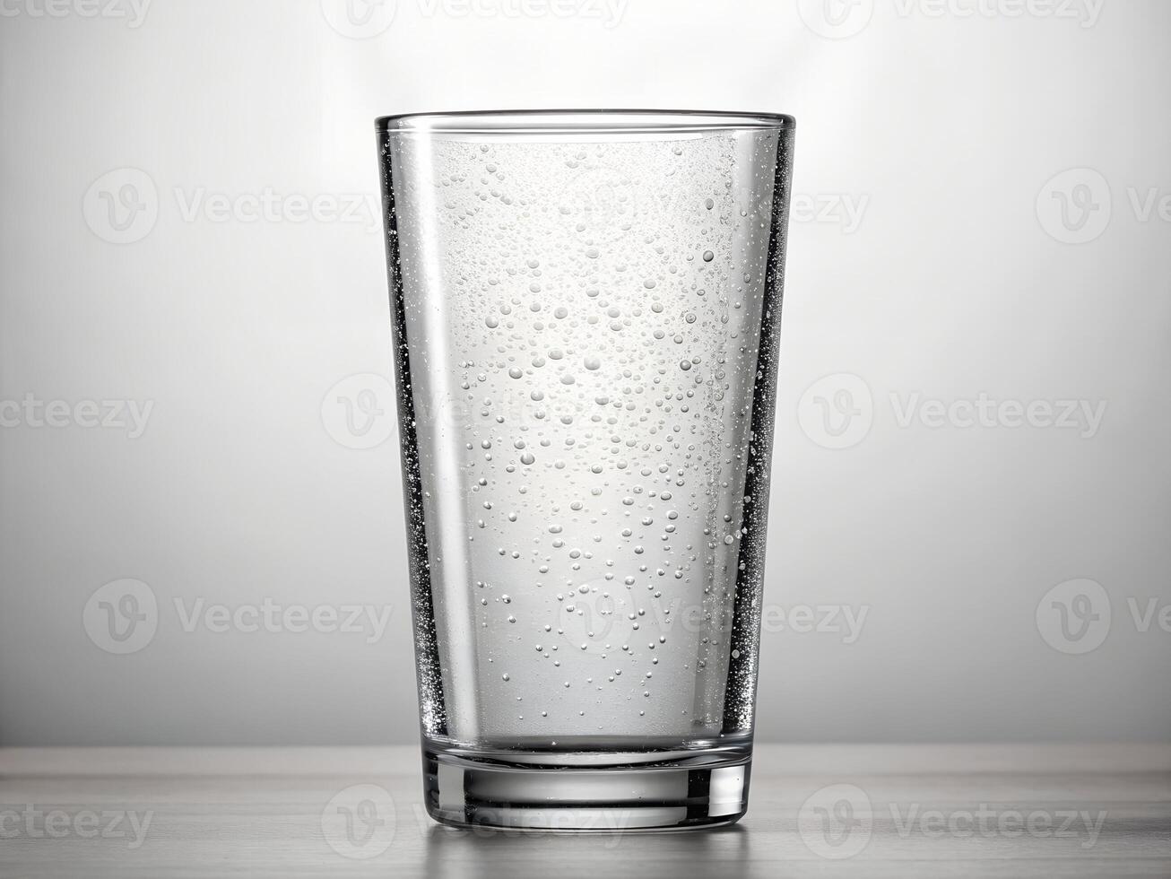 Clear Glass of Sparkling Water on White Background photo