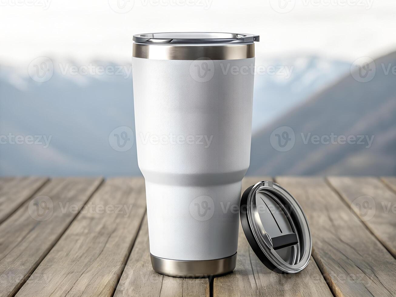 White Stainless Steel Tumbler on Wooden Table with Mountain Background photo