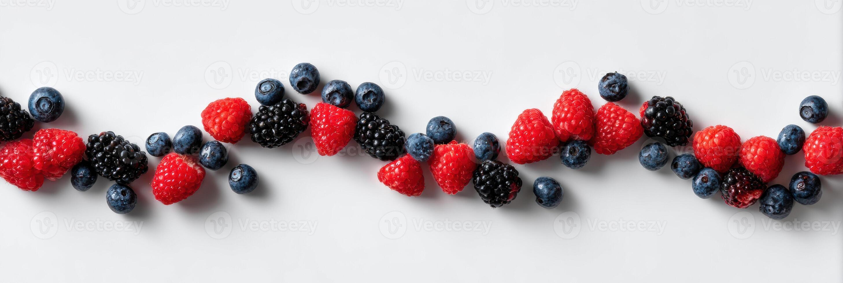 Berries Arranged in a Symmetrical Wave Formation on a Clean White Surface With Open Space photo