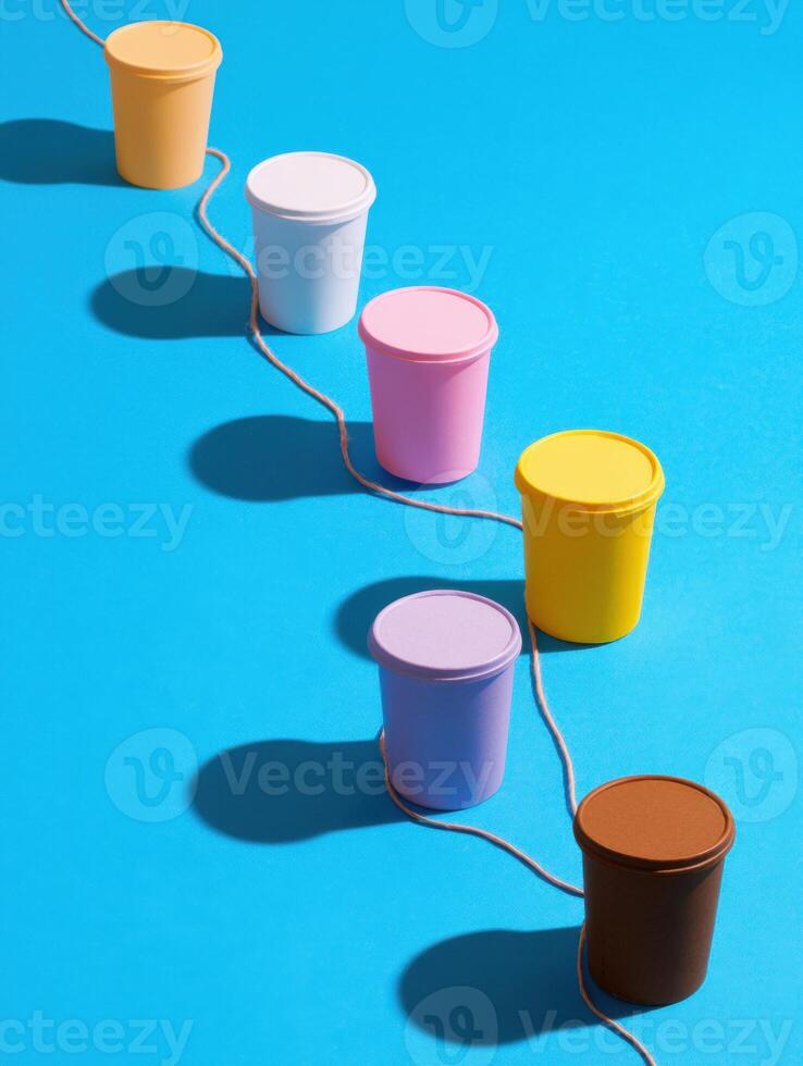 Creative Connection Using Paper Cups and String in a Colorful Workspace Setting Promoting Communication and Playfulness photo