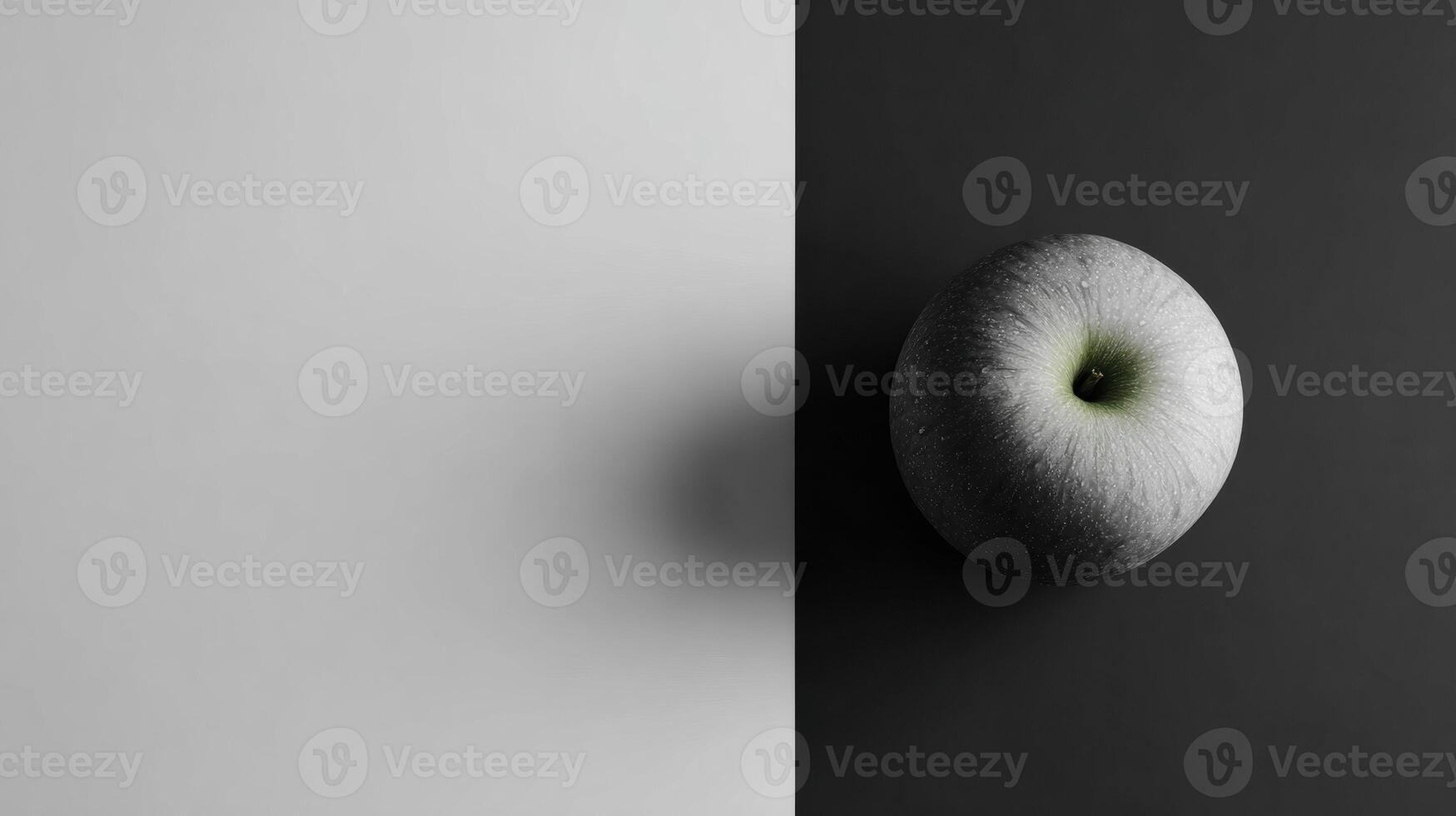 Minimalist Grayscale Layout Featuring a Single Colored Apple Emphasizing Contrast and Simplicity in Composition photo