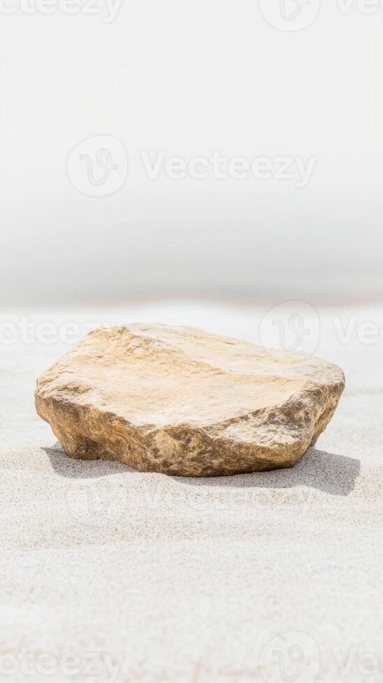 Natural Stone Pedestal on Pristine White Sand A Minimalist Display for Product Showcase or Serene Background. Earthy Tones and Organic Texture photo