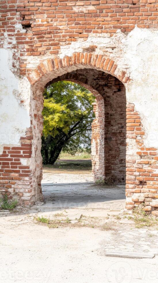 Ancient Brick Archway Ruin A Weathered Historic Passage Revealing Nature's Embrace Through Crumbling Walls and Verdant Foliage photo