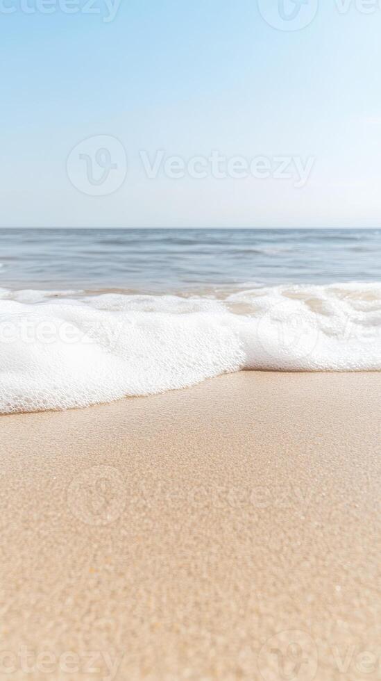 Serene Coastal Horizon Gentle Ocean Waves Kissing Golden Sand on a Bright, Clear Day, Evoking Tranquility and Summer Bliss photo