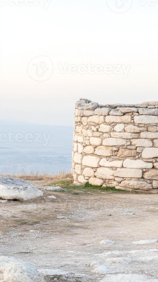 Ancient Stone Wall Ruin Overlooking Vast Landscape A Timeless Architectural Structure with Historic Charm and Serene Horizon Views photo