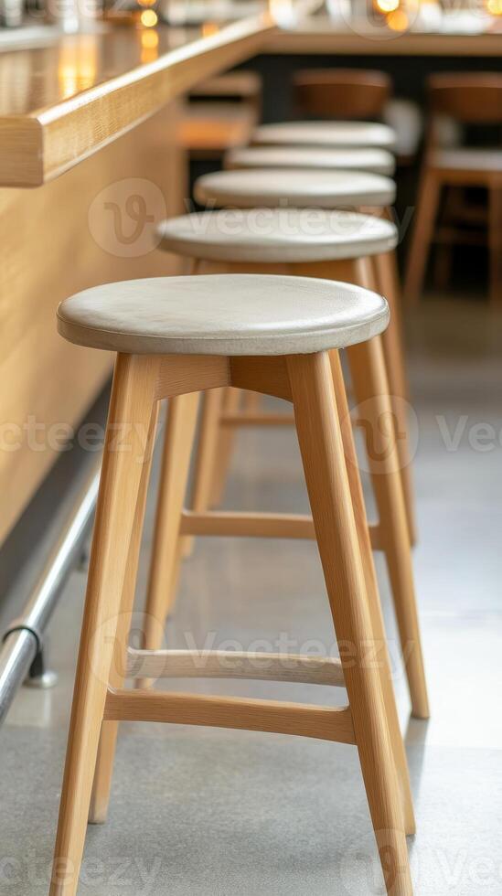 Modern Wooden Bar Stools Lined Along a Sleek Counter in a Contemporary Cafe Interior, Evoking a Serene and Inviting Hospitality Space. photo