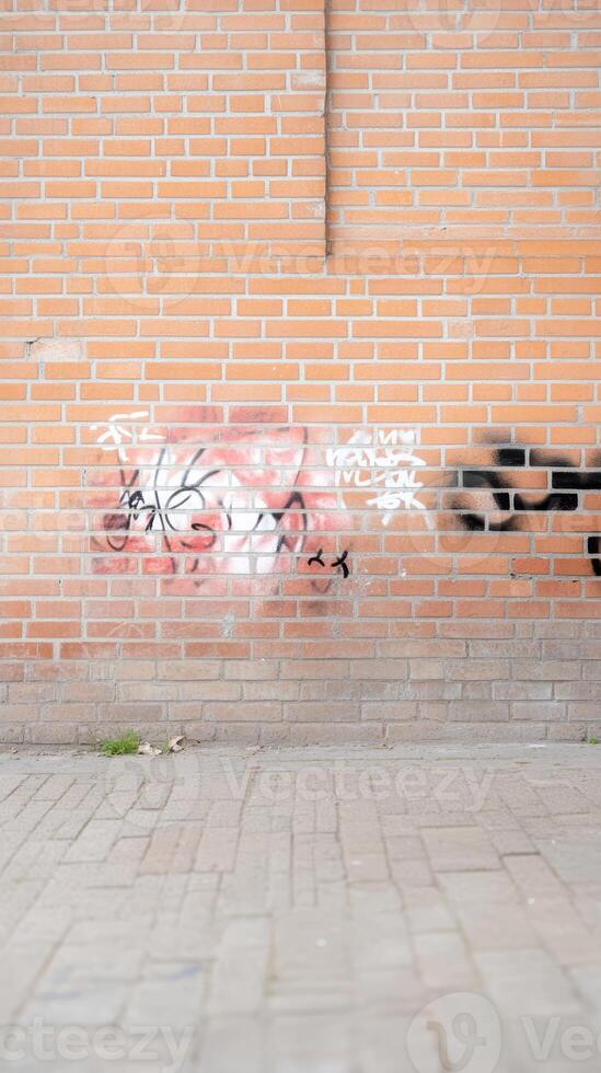 Vibrant street art adorns a textured brick wall, showcasing urban decay and creative expression on a gritty city facade. A compelling visual narrative. photo